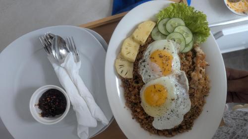 a plate of food with eggs and vegetables on a table at Kandy Alpine Breeze in Kandy