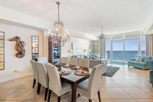 a dining room and living room with a table and chairs at Turquoise Place 2205 C in Orange Beach
