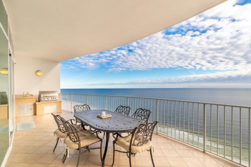 a balcony with a table and chairs and the ocean at Turquoise Place 2205 C in Orange Beach