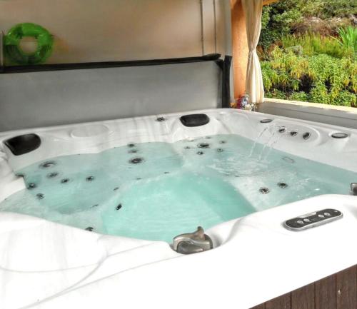 a bath tub with a water fountain in it at Maison charmante à Montauroux avec jacuzzi et vue in Montauroux