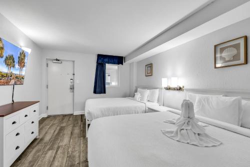 a hotel room with two beds and a tv at Boardwalk Resort Oceanfront Condo by Hosteeva in Myrtle Beach