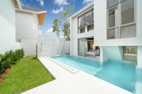 a swimming pool in the backyard of a house at Exclusive Living in Designer 4BR Pool Villa in Lux Pride 2 V11 Residence, Near Laguna in Bang Tao Beach