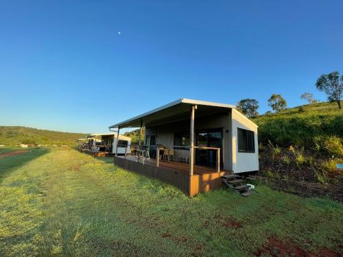 a house that is on the side of a field at High Valley Dawn Permaculture Farm in Yeppoon