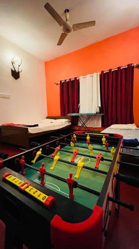 a room with a pool table with people on it at Coorg Tribal Land homestay in Kushālnagar