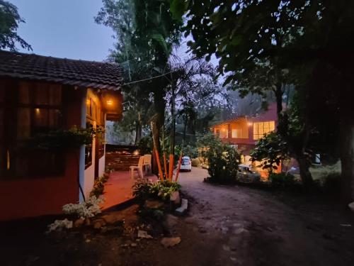 a view of a house at night at Coorg Tribal Land homestay in Kushālnagar