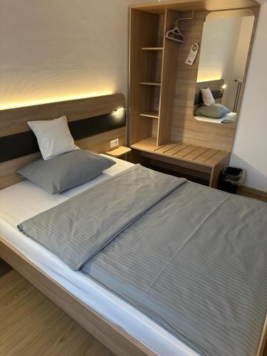 a bedroom with a large bed and a mirror at Hotel Am Vogelsanger Weg in Düsseldorf