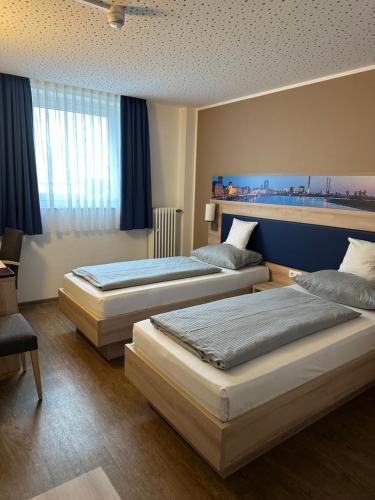 Postel nebo postele na pokoji v ubytování Hotel Am Vogelsanger Weg