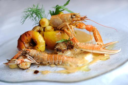 a plate of food with a lobster and vegetables at Le Val d'Amby in Hières-sur-Amby
