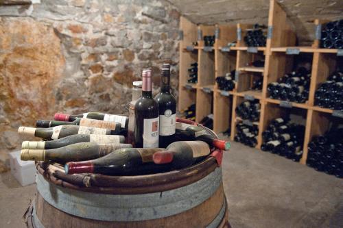 a barrel full of wine bottles in a wine cellar at Le Val d'Amby in Hières-sur-Amby