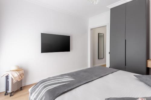 a bedroom with a bed and a tv on the wall at Crystal Luxury in Craiova