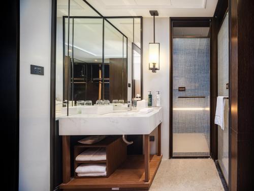 a bathroom with a sink and a mirror at Hilton Garden Inn Beijing Guomao in Beijing
