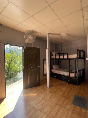 a room with two bunk beds and a door at Social Quarters Blanco - Youth Hostel 18 to 35 Only in Railay Beach