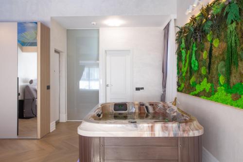 a bathroom with a sink and a painting on the wall at Crystal Luxury in Craiova