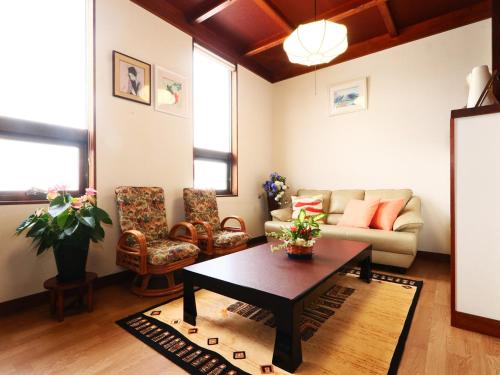 a living room with a couch and a table at 民宿東海 in Makinohara