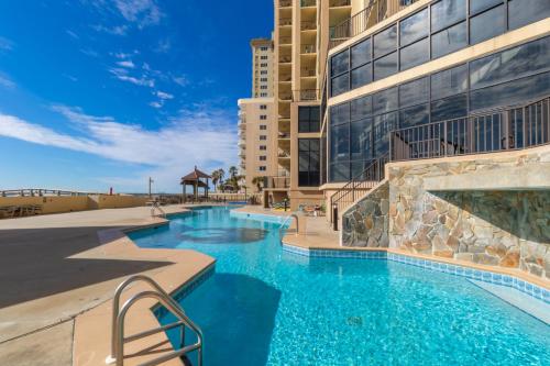 a swimming pool in front of a building at Phoenix I 1085 in Orange Beach