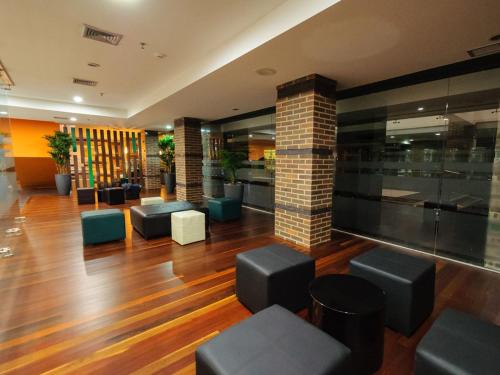 a lobby with couches and chairs in a building at Hotel Alex Caracas in Caracas