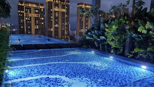 a large swimming pool on the roof of a building at Revo Aurora Place Bukit Jalil in Kuala Lumpur