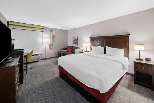 a hotel room with a large bed and a television at Hampton Inn Franklin in Franklin