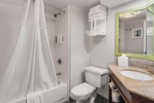 a white bathroom with a toilet and a sink at Hampton Inn New Bedford/Fairhaven in Fairhaven