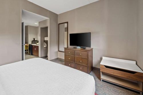 a bedroom with a bed and a flat screen tv at Hampton Inn New Bedford/Fairhaven in Fairhaven