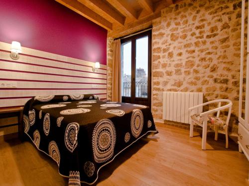 a bedroom with a large bed in a brick wall at La Casa de Beli in Tardajos