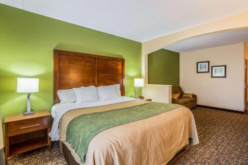 a hotel room with a large bed and a chair at Comfort Inn & Suites Panama City North in Panama City