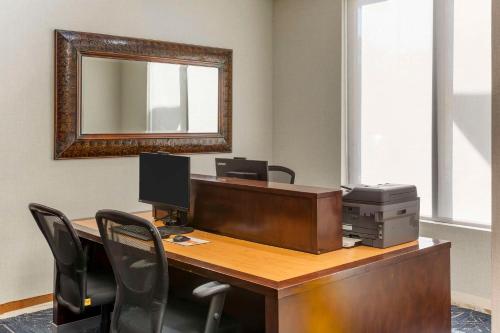 an office with a desk with a computer and a mirror at Comfort Suites Ogden Conference Center in Ogden