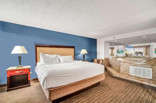 a bedroom with a large bed and a bath tub at Radisson Hotel Schaumburg in Schaumburg