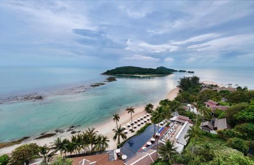 an aerial view of a beach with palm trees and the ocean at Anantara Lawana Koh Samui Resort in Chaweng