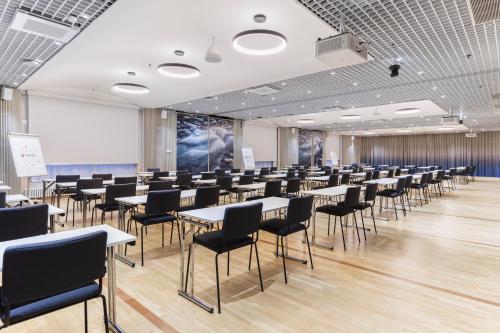 a room with tables and chairs in a classroom at Original Sokos Hotel Vantaa in Vantaa
