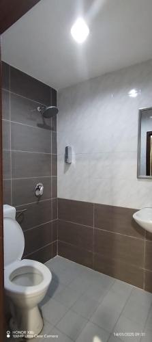 a bathroom with a toilet and a sink at The Great Hotel in Ipoh
