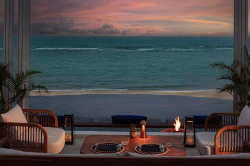 a room with a table with a view of the ocean at Anantara Lawana Koh Samui Resort in Chaweng