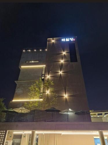 a tall building with lights on it at night at House of Gallery Hyomok in Daegu