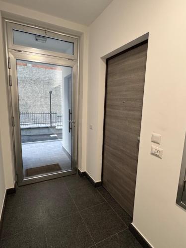 a door leading to a hallway with a glass door at HilMar Holiday Home in SantʼAgata di Militello