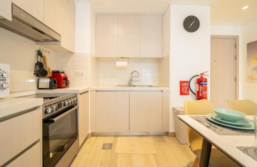 a kitchen with white cabinets and a sink and a counter at ZAPBED House - Luxury Holiday Homes in Yas Island in Abu Dhabi