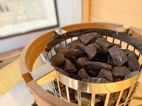 a basket of brown rocks sitting on a table at MitO Onomichi - Sauna & Scenic 3-Story Stay in Kaneyoshi