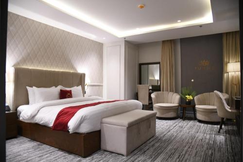 a hotel room with a large bed and a desk at TAJ Hotel in Islamabad