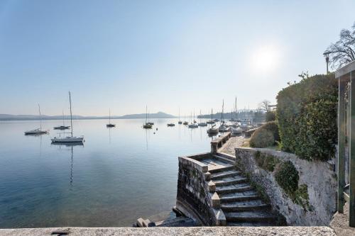 a view of a harbor with boats in the water at Sunset on the Lake Belgirate in Belgirate