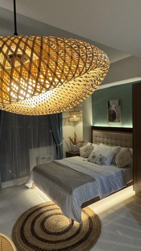 a large chandelier above a bed in a bedroom at Slai Staycation Near Mactan Newtown in Lapu Lapu City