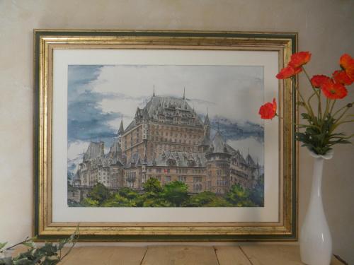 a painting of a building with a vase of flowers at Le Val d'Amby in Hières-sur-Amby