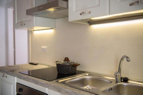 a kitchen with a sink and a counter top at Casa Margherita 1P, Borno Ospitar in Borno