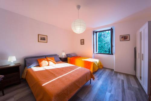 a bedroom with two beds and a window at Casa Margherita 1P, Borno Ospitar in Borno