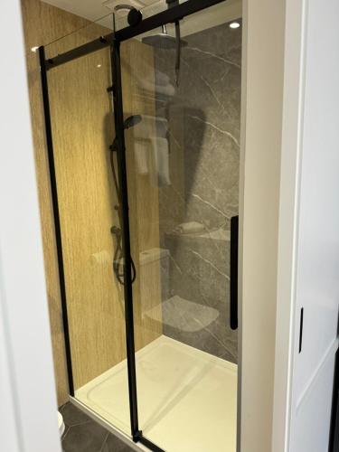 a shower with a glass door in a bathroom at Pleasant Place in Lowestoft