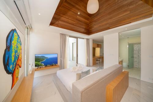 a living room with a couch and a table at Your Private Piece of Paradise! 4BR Pool Villa in the New Lux Pride 2 V9 Residence in Ban Pak Lak