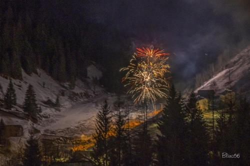 a fireworks display in front of a mountain at night at ALBERGO VALLUNGA in Tartano