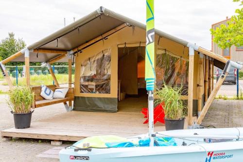 a tent with a boat in front of it at Safari tent Heeg 4 persons in Heeg