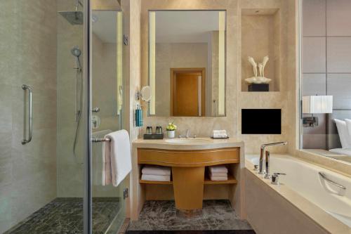 a bathroom with a sink and a shower at DoubleTree by Hilton Guangzhou - Canton Fair Free Shuttle Bus & Exhibition Registration Service in Guangzhou