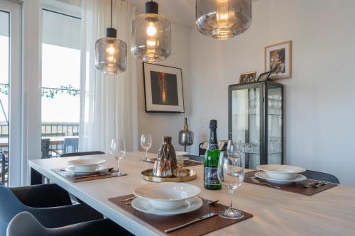 a dining room with a table with plates and wine glasses at Harbour Loft 1G in Kamperland