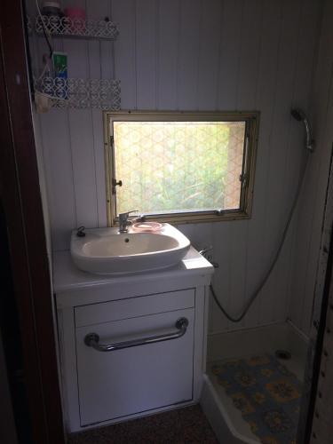 a small bathroom with a sink and a window at Duży kemping in Ustronie Morskie