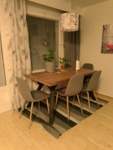 a dining room table with four chairs and a table at Accommodation near the Arctic Circle in Rovaniemi